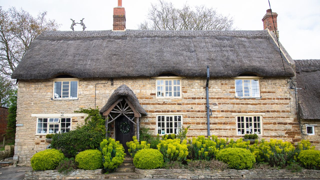 exterior of a thatched cottage with wooden porch