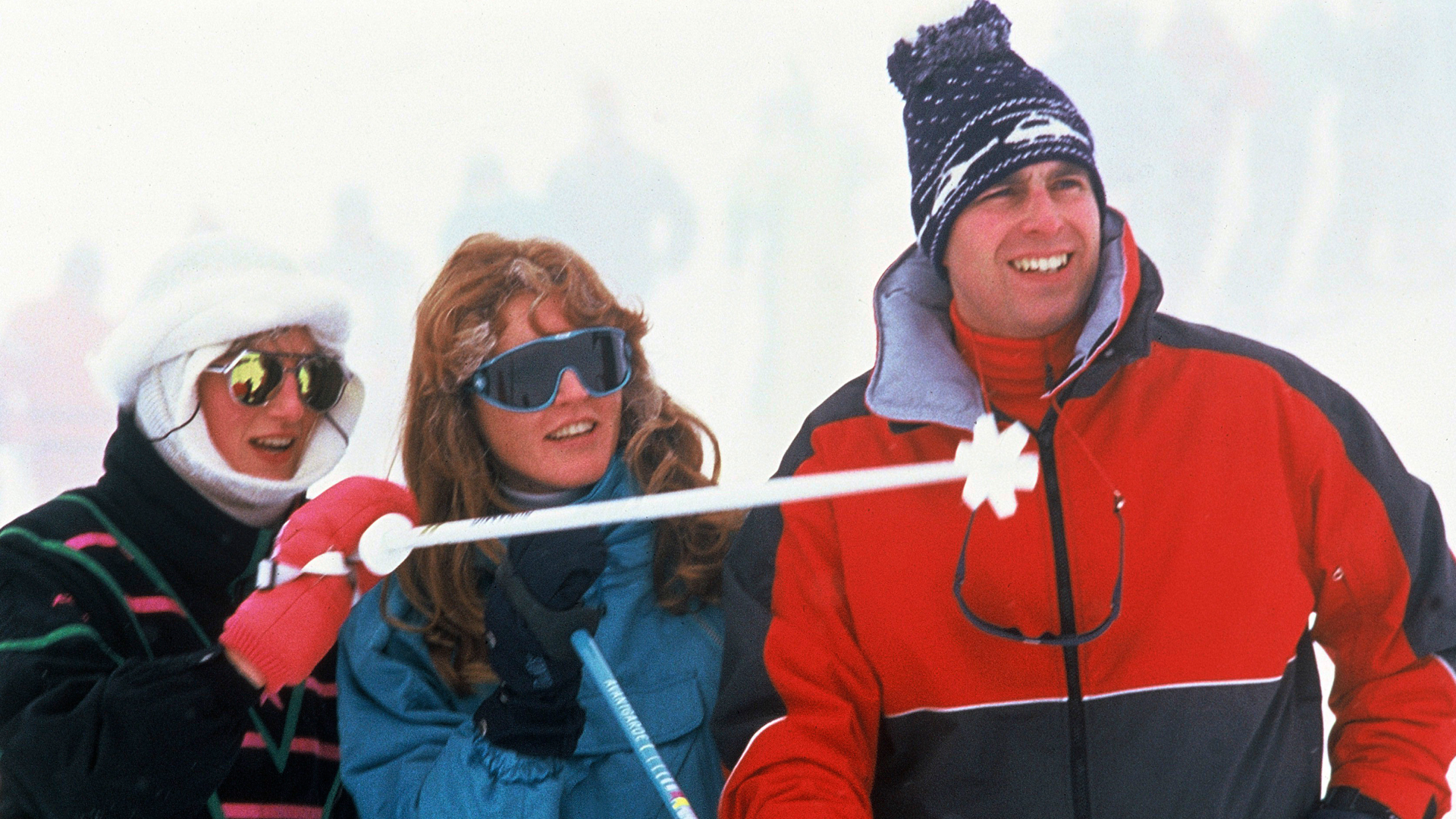 Princess Diana, Sarah Ferguson and Prince Andrew laughing and wearing ski suits