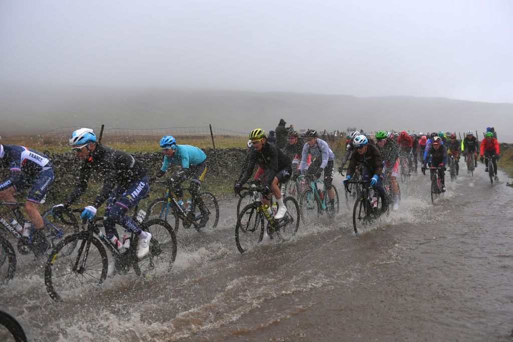 The riders push on through deep water early in the elite men's road race