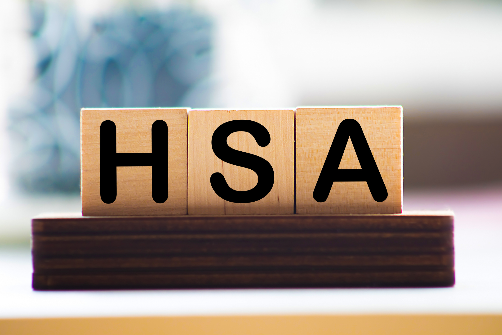 Health Savings Account HSA letters from wooden blocks.