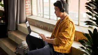 Man with HP X360 on his lap