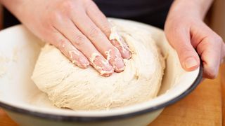 Dough being shaped in a bowl