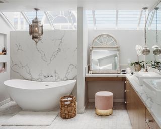 white marble bathroom with tub and vanity unit