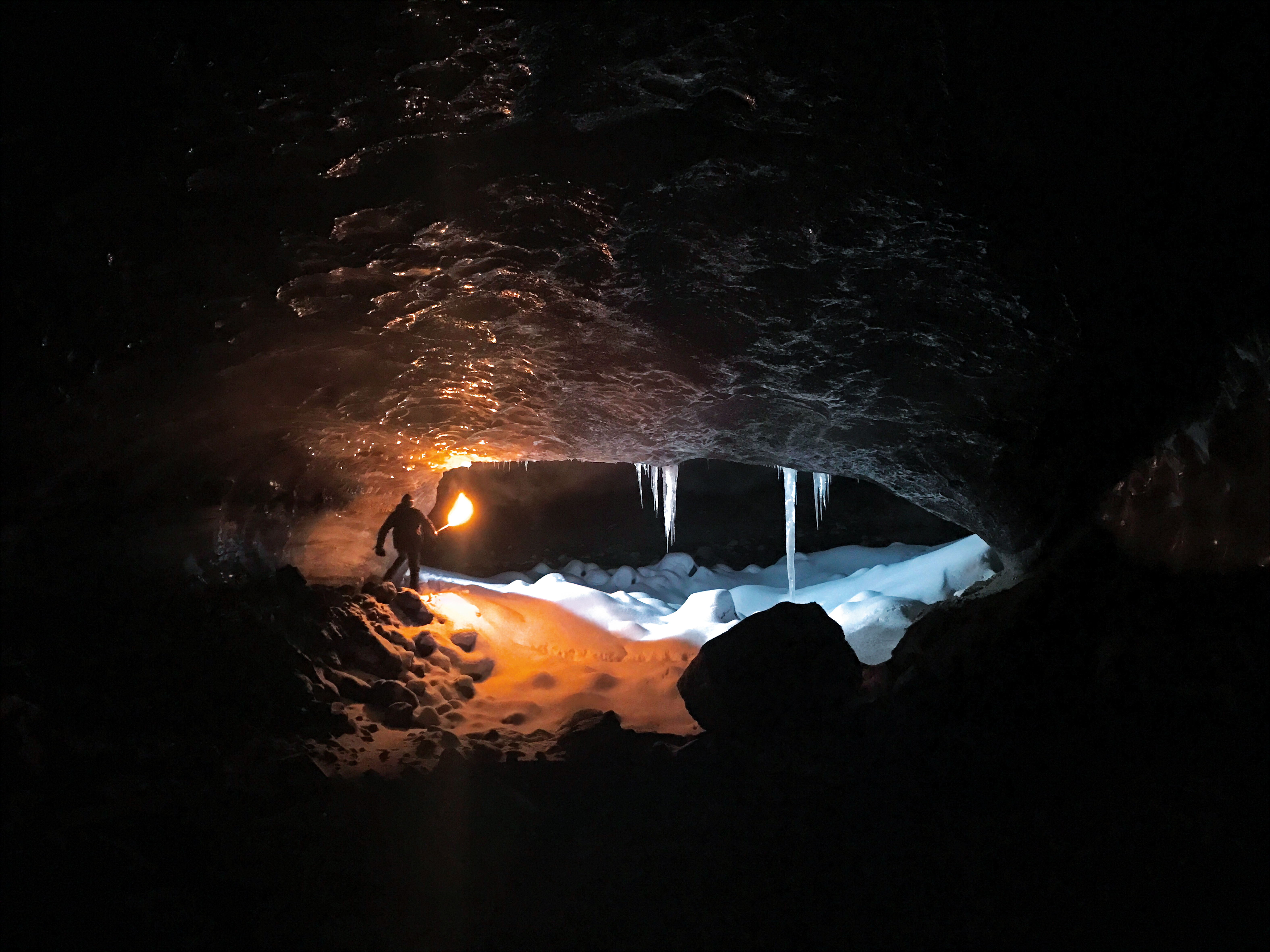 'Ruairidh McGlynn traveled by dogsled through Iceland, stopping for a break in this ice cave.'