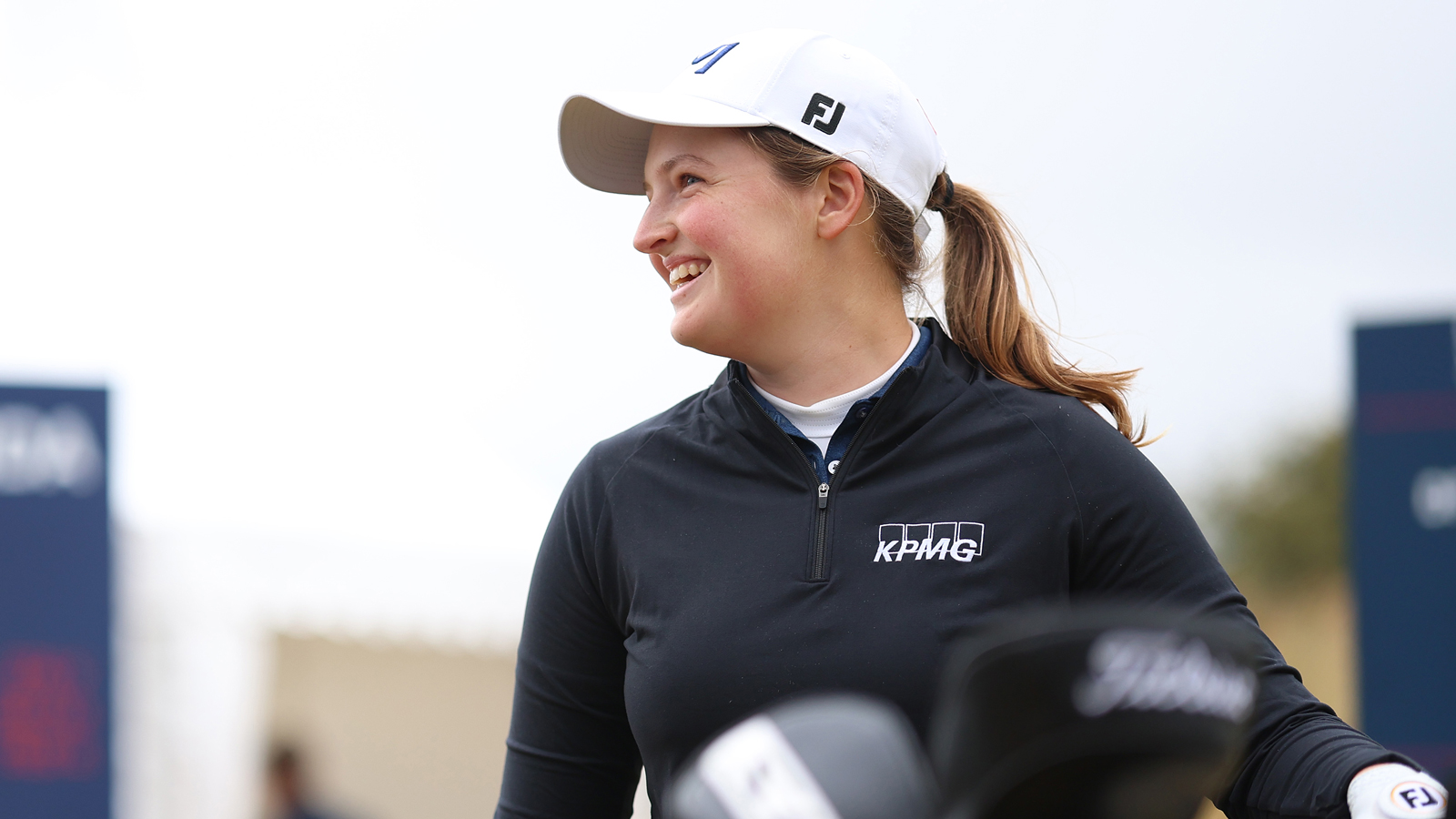 Lottie Woad smiles on the tee box