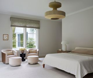 bedroom with large pendant lamp and cream walls