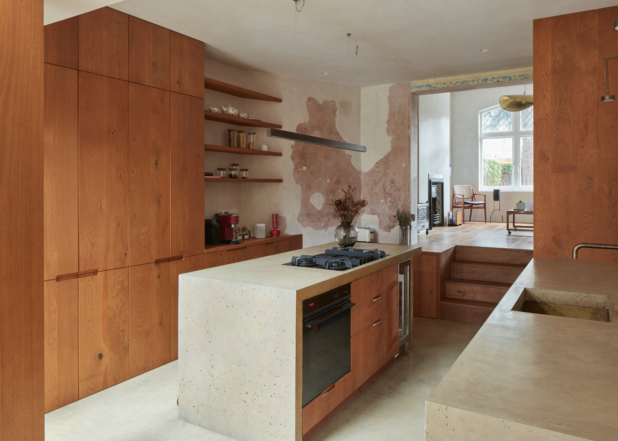 reclaimed wood cabinets in an industrial, modern kitchen with concrete island and counters