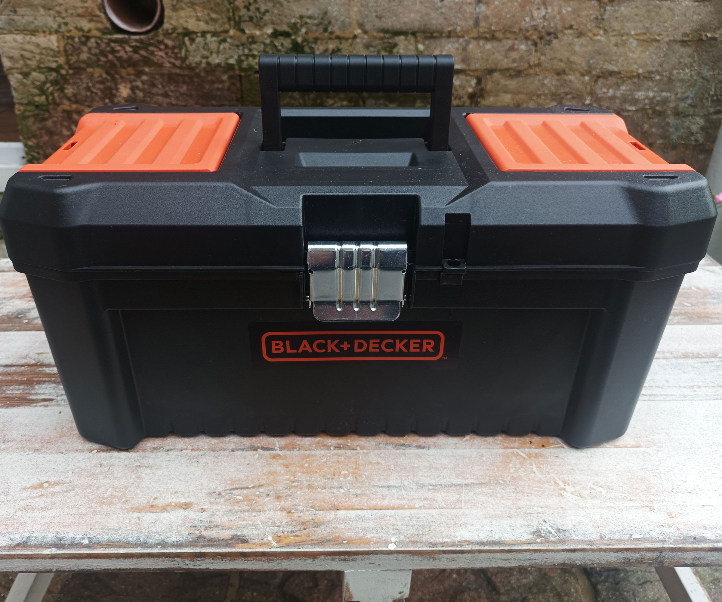 Black Decker MultiEvo Multi Tool ToolBox on wooden table against brick background