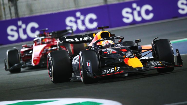Max Verstappen of the Netherlands driving the (1) Oracle Red Bull Racing RB18 Honda waves Charles Leclerc of Monaco driving (16) the Ferrari F1-75 