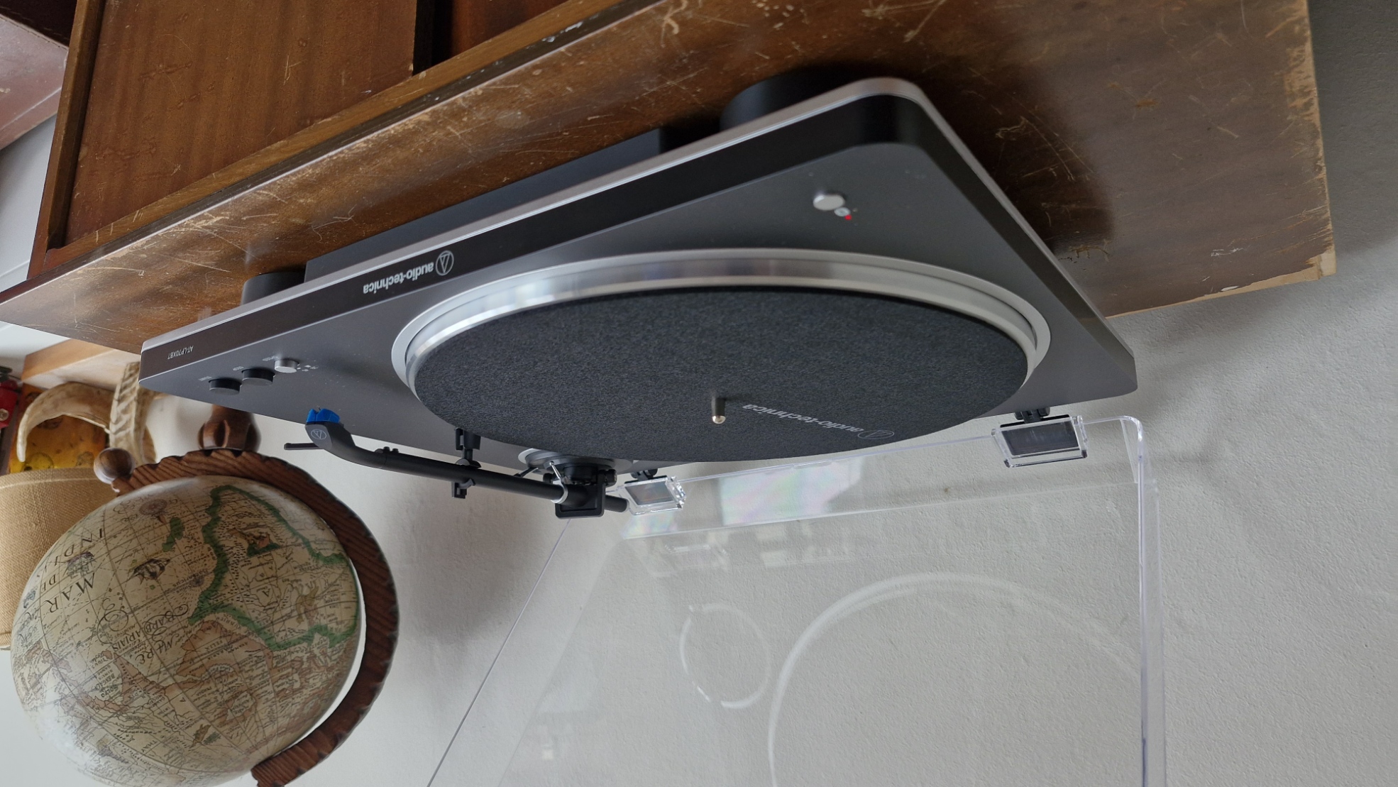 Audio-Technica AT-LP70XBT turntable, with the dust cover open, on a wooden table