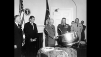 President Eisenhower inspects the capsule from Discoverer 13.