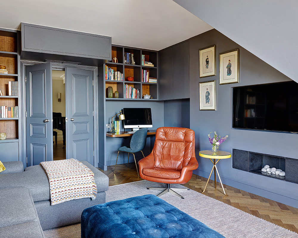 Gray apartment living room ideas with built-in storage, a pale sectional sofa and orange leather armchair.