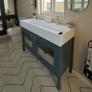 double vanity in bathroom with zig zag tiles and brass accents