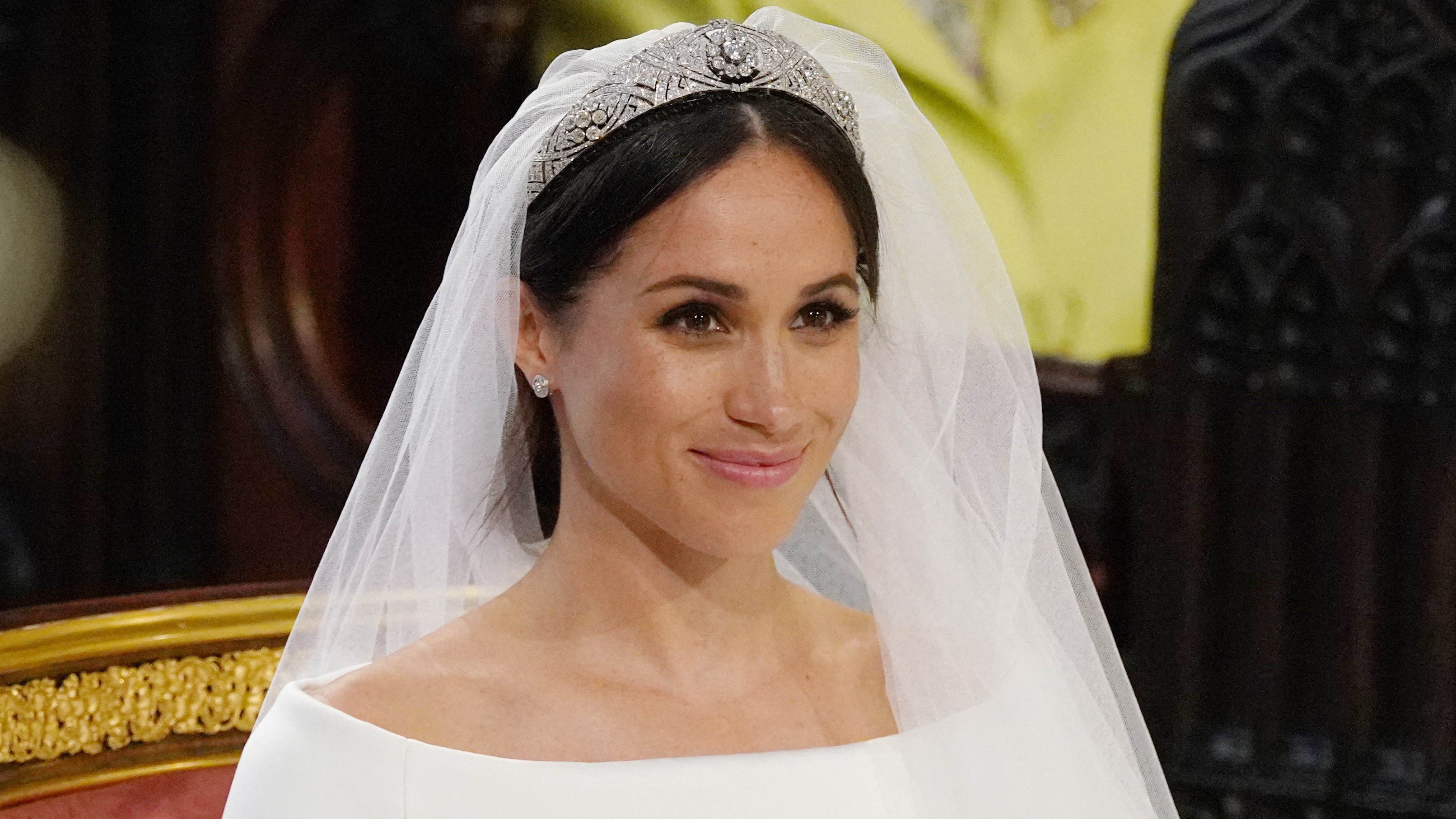 Meghan Markle sits at the High Altar wearing a tiara at her wedding ceremony in St George&#039;s Chapel, Windsor Castle