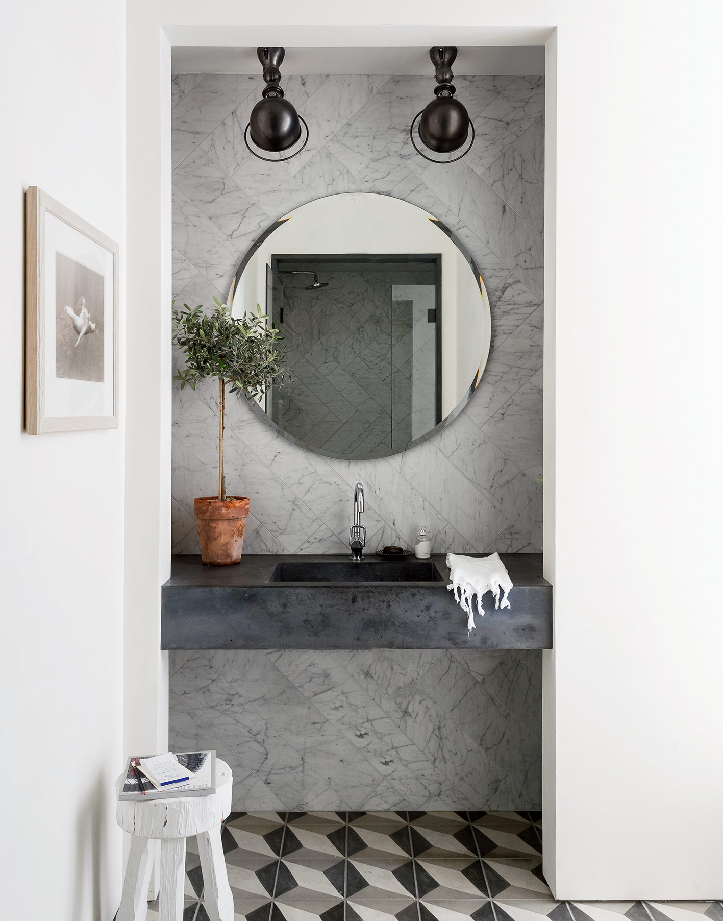 small modern bathroom with marble wall tiles and patterned floor tiles