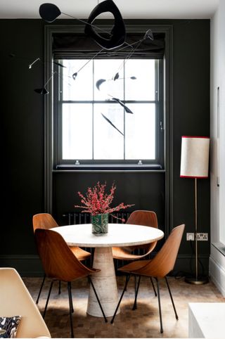 Dark dining area with Mid-century modern dining table and chairs