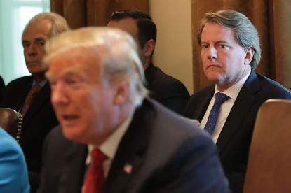 Don McGahn looks at the back of Donald Trump's head.