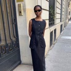 Sylvie Mus wearing a black linen Posse vest and skirt set