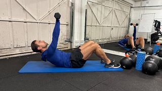 Personal trainer at Bio-Synergy Jay Conroy performing an above the head abdominal crunch