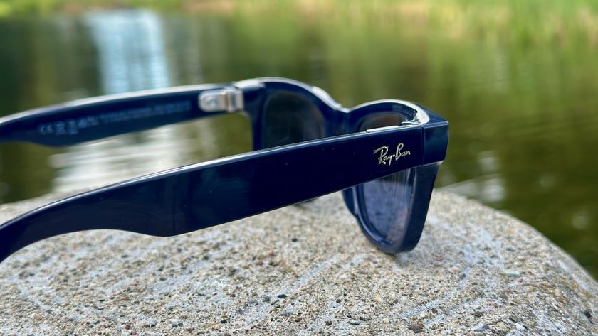 A photo of the Ray-Ban Meta (Gen 2) smart glasses sitting on a rock, angled to focus on the right arm with the Ray-Ban logo.
