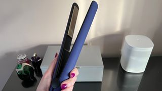 The Hot Tools Pro Signature Digital Straightener being held in a hand