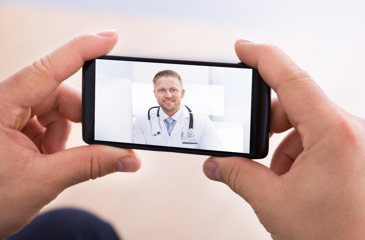 Man Video Chatting With Doctor