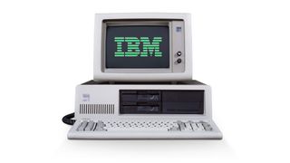 A front view of the IBM Personal Computer on a plain white background with the IBM logo on the screen in green