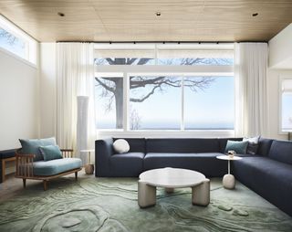 blue L sofa and armchair on textured wool sea green rug