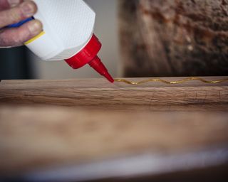 A carpenter gluing wood