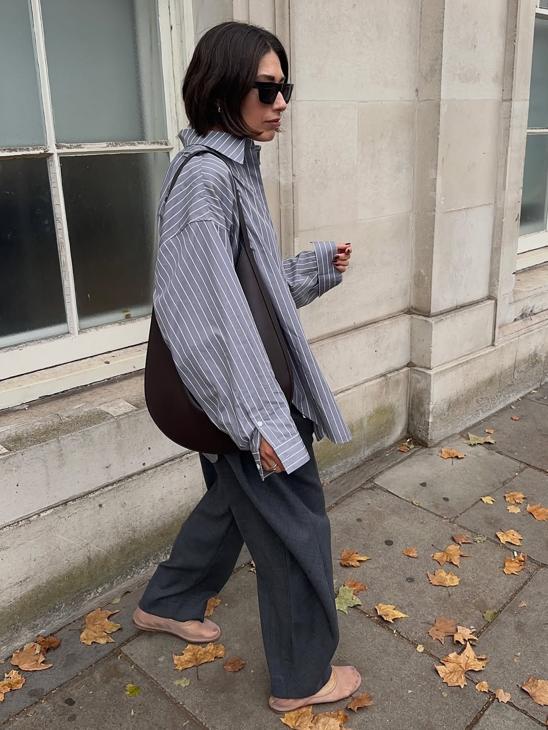 Influencer Lucy Alston wearing a light grey shirt and dark grey trousers.