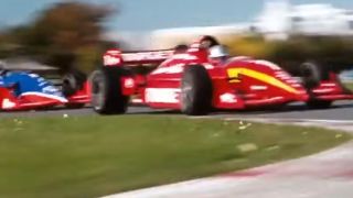 a blur of race cars as they race around a track