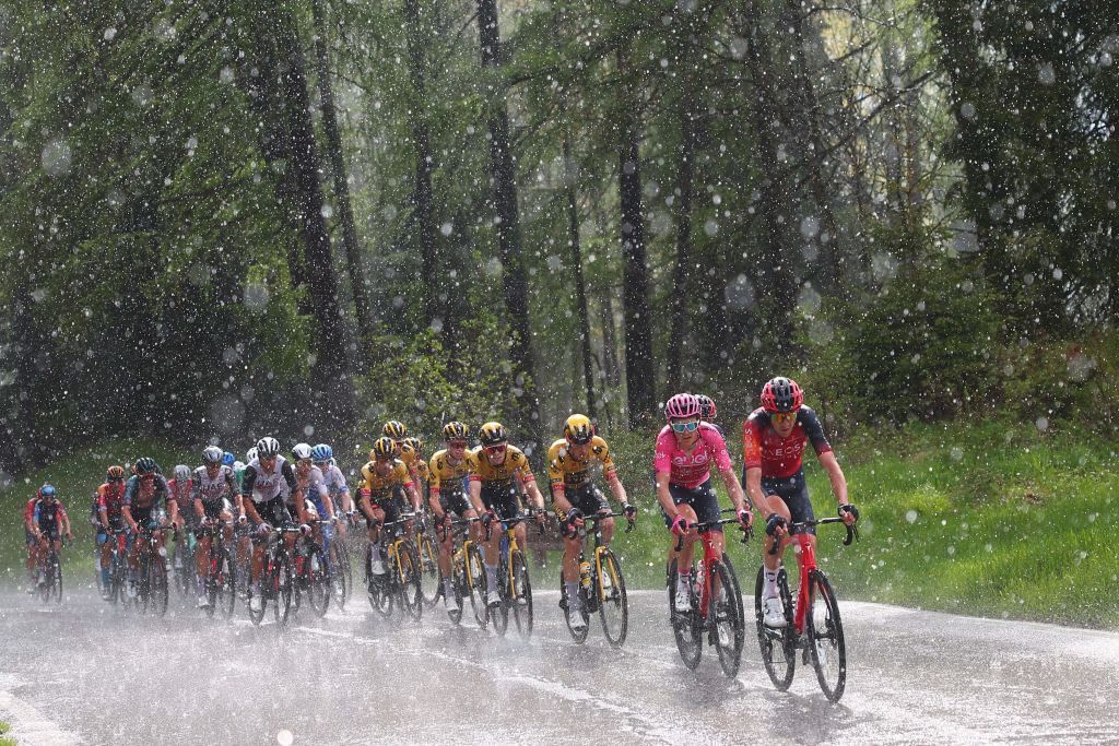 TOPSHOT Overall leader INEOS Grenadierss British rider Geraint Thomas 2ndR and riders of the pack cycle under pouring rain across the Passo Tre Croci pass in the Dolomites mountains during the nineteenth stage of the Giro dItalia 2023 cycling race 183 km between Longarone and Tre Cime di Lavaredo rifugio Auronzo on May 26 2023 Photo by Luca Bettini AFP Photo by LUCA BETTINIAFP via Getty Images