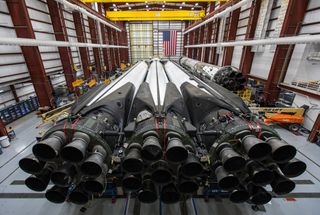 The SpaceX Falcon Heavy rocket that will launch the Saudi Arabian satellite Arabsat 6A is seen in its hangar near NASA's Kennedy Space Center Launch Complex 39A in Cape Canaveral, Florida. Liftoff is set for April 10, 2019.