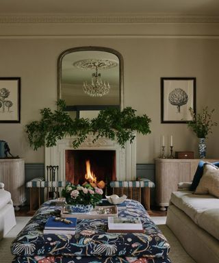 Grand traditional living room with fireplace and foliage on mantelpiece