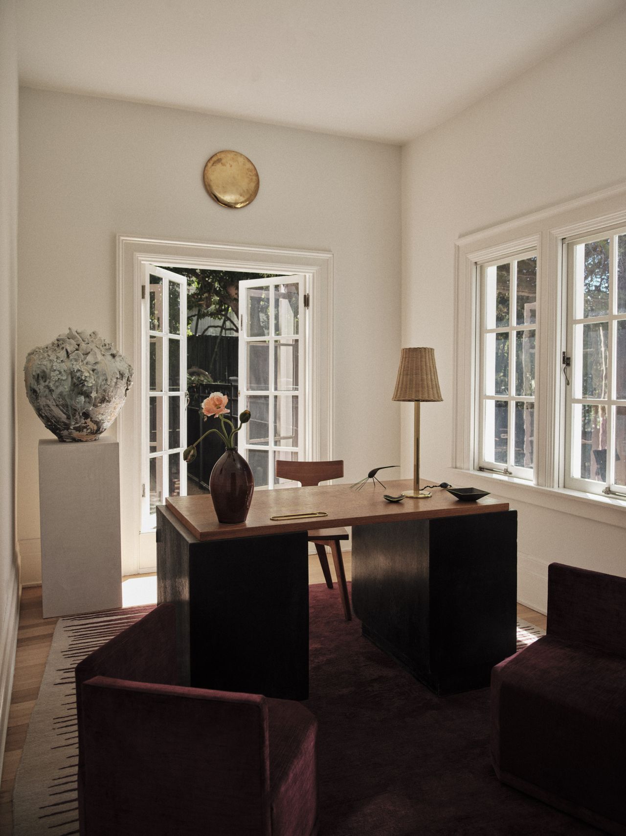 A beautifully decorated room opens up to a garden.