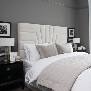 Monochrome bedroom with art deco influences and padded headboard