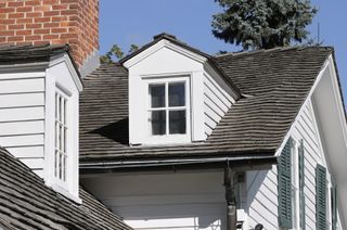 Traditional American Architecture with dark roof and panelled exterior walls