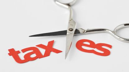 scissors cutting the word taxes