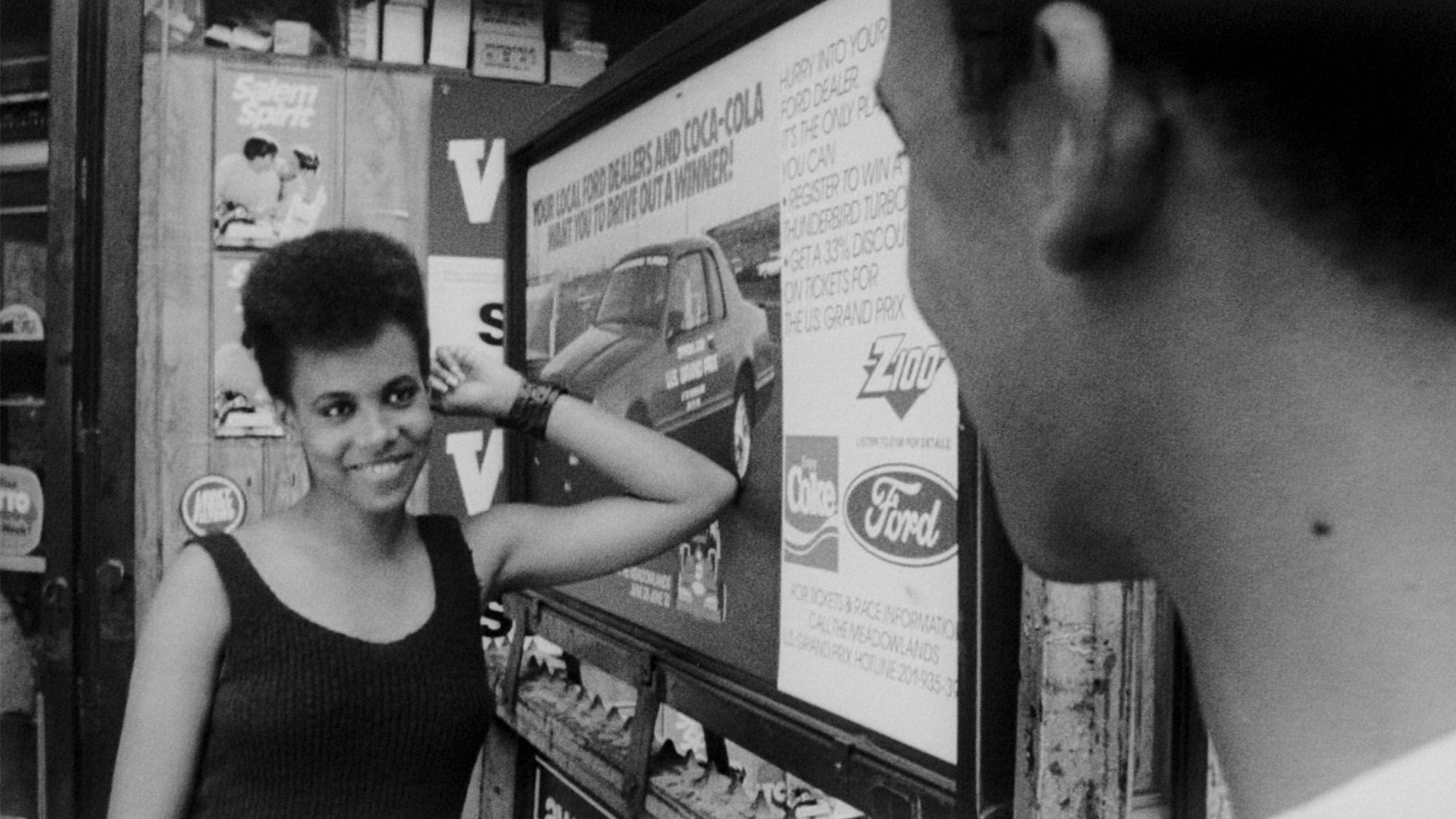 A woman in black and white flirting and smiling in She's Gotta Have It