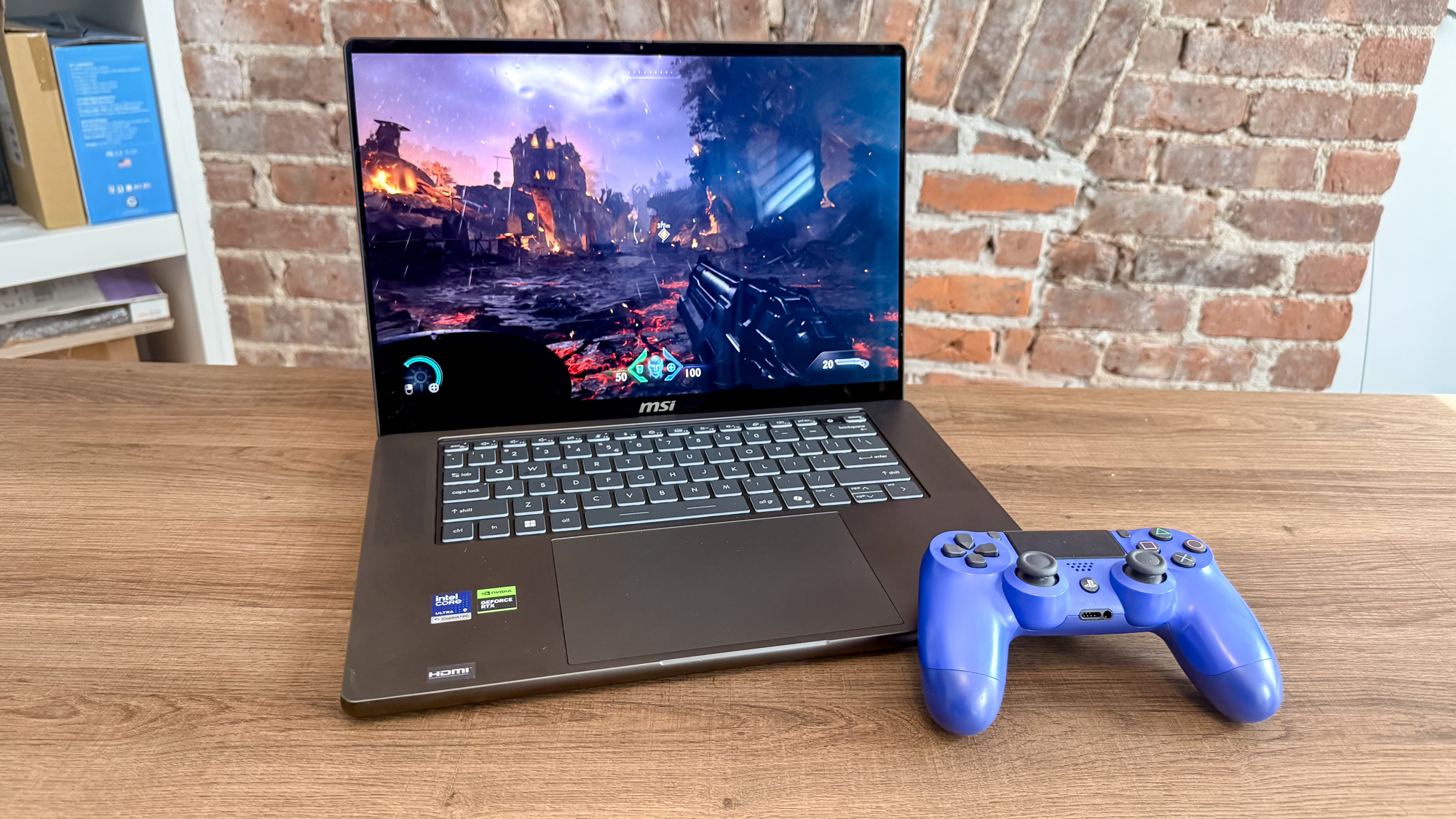 The MSI Stealth 16 AI+ (2026) running a game with a controller next to it