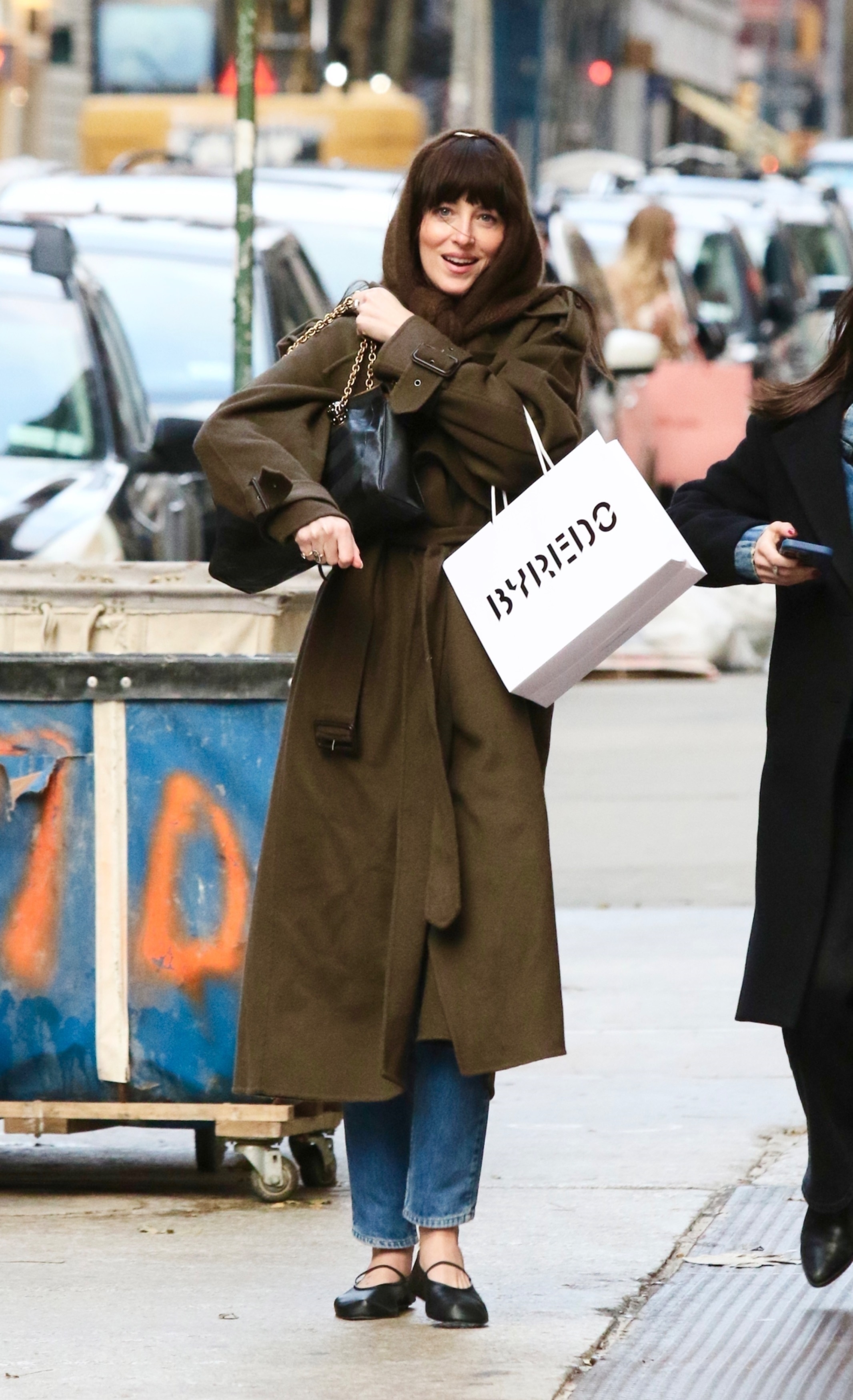 Dakota Johnson sports a stylish wardrobe with a headscarf while shopping in NYC