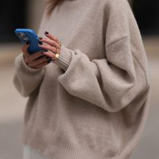 prime day fashion deals - woman looking on her phone getty images 2149652141