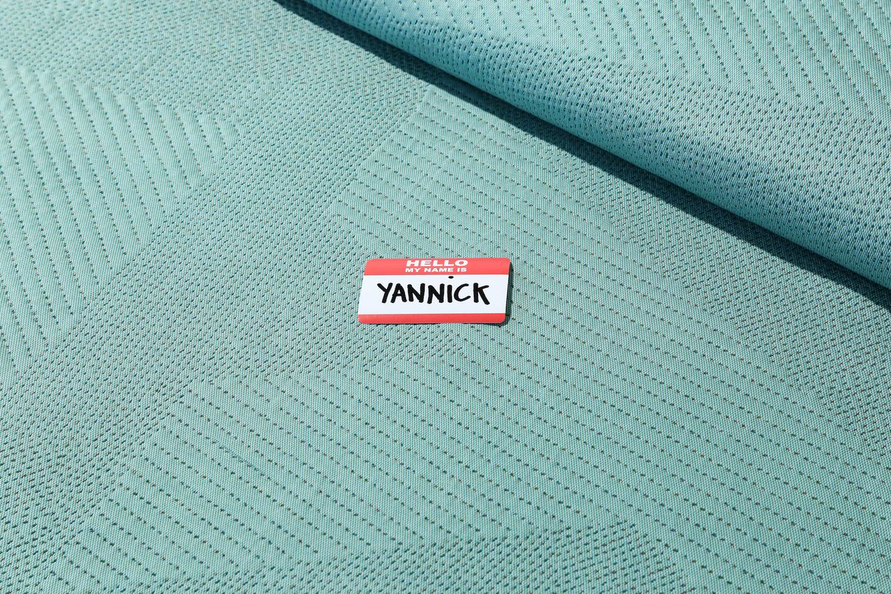 Coloured Byborre fabric with name tag on it which reads &#039;Hello my name is Yannick&#039;