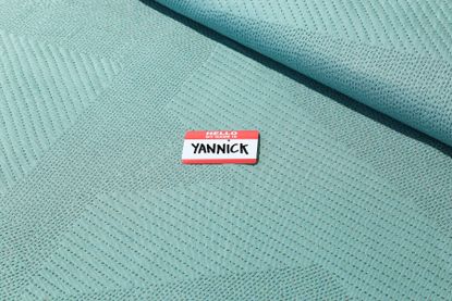 Coloured Byborre fabric with name label on it which says 'Hello my name is Yannick'