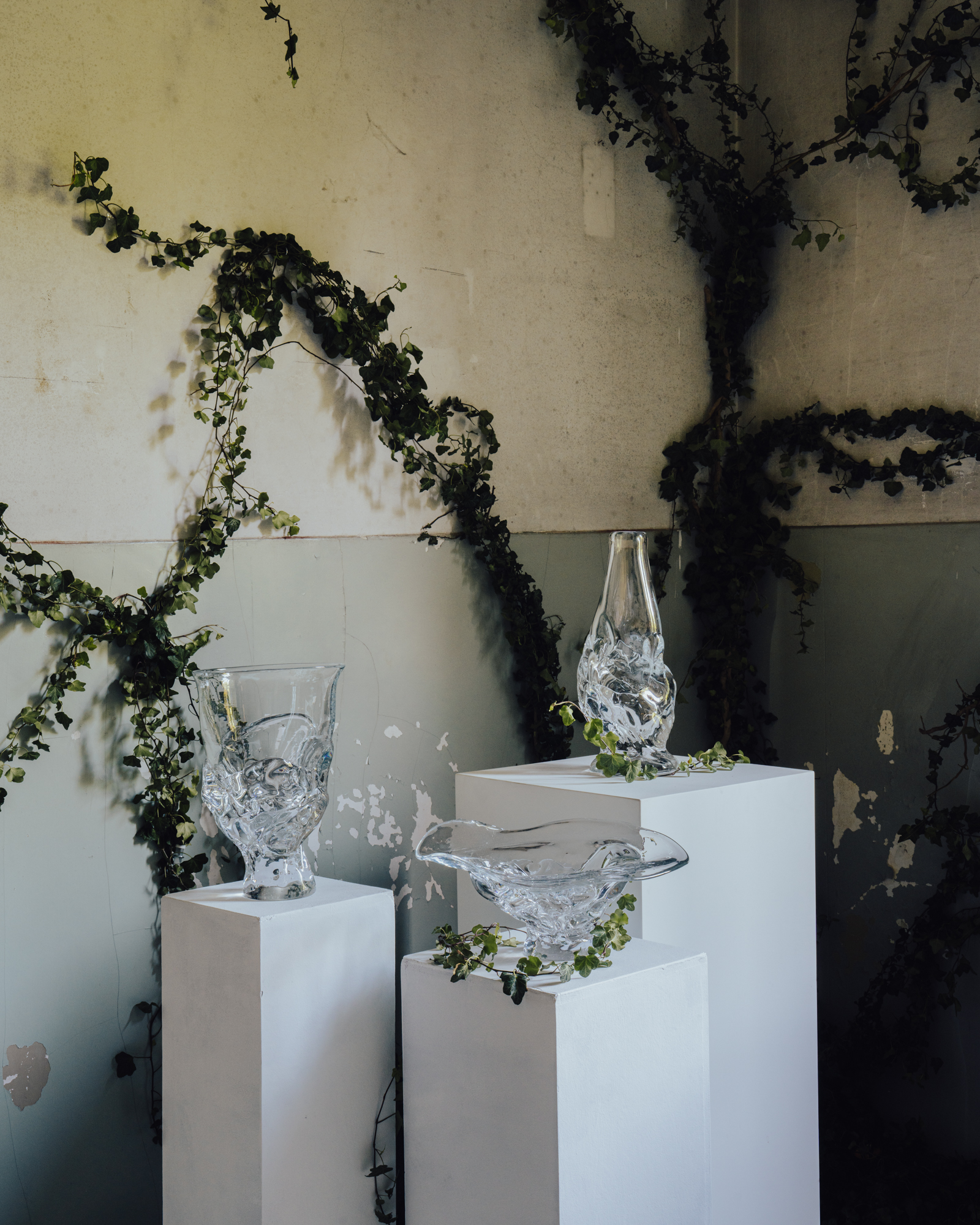 clear glass vessels on white plinths
