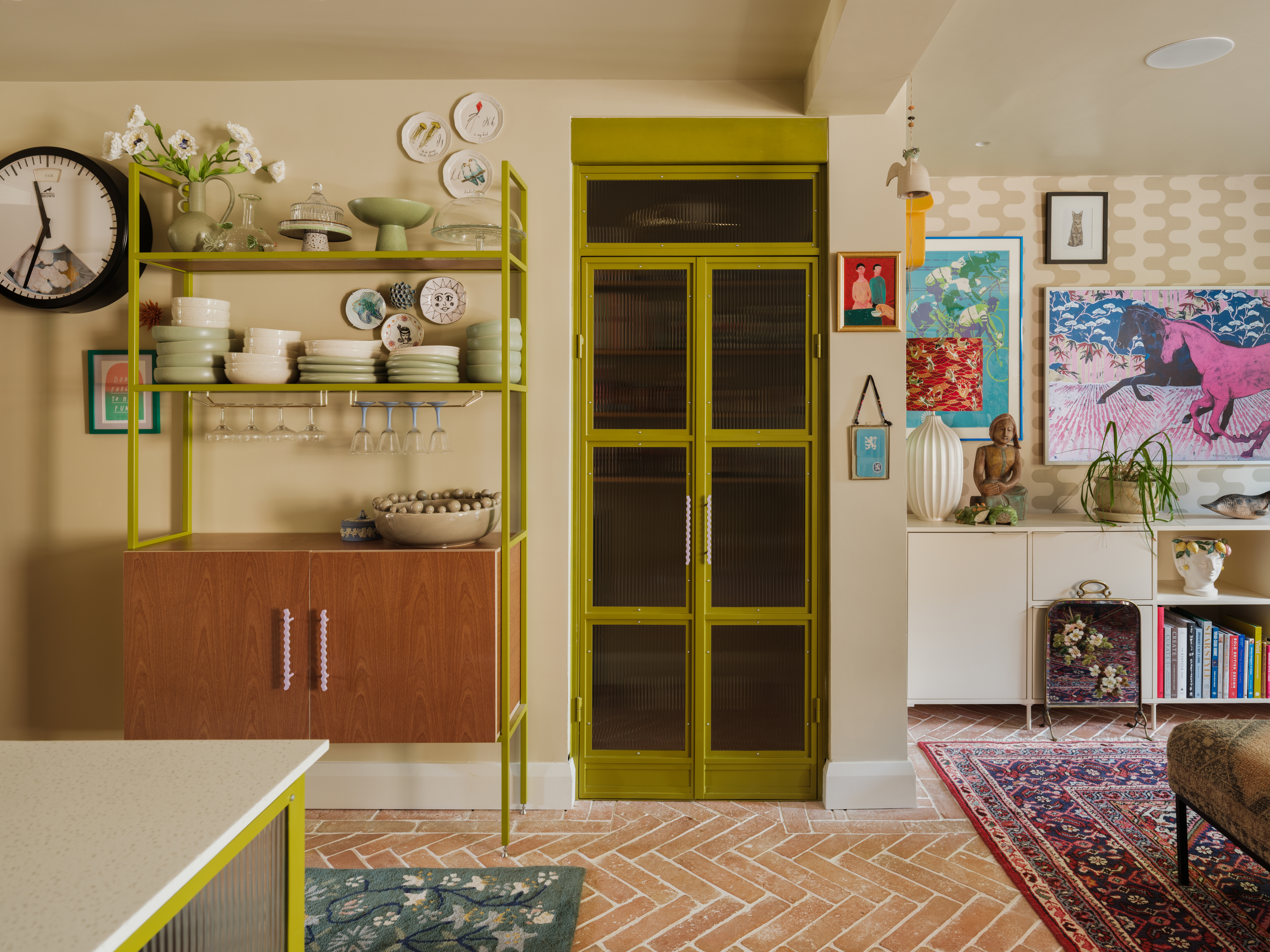 Kitchen with midcentury-style dresser and glazed door with chartreuse painted frame