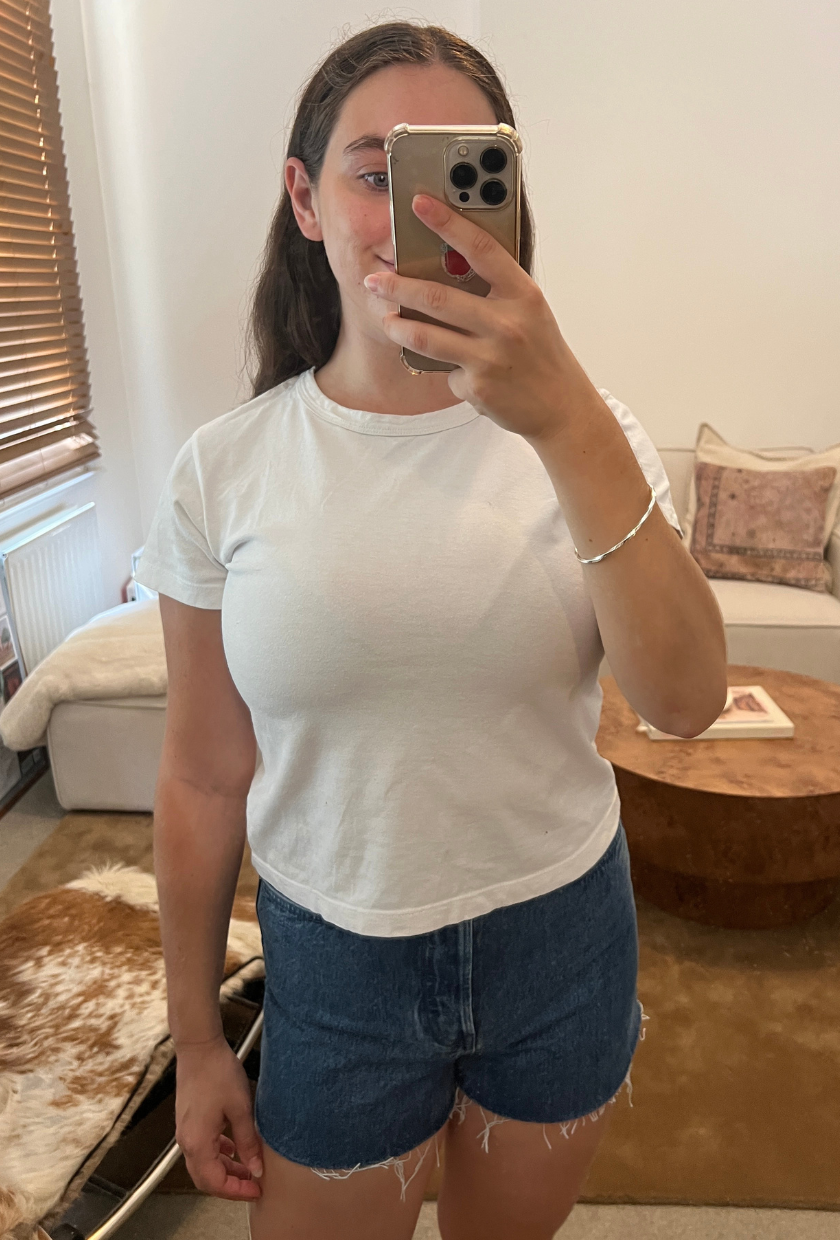 An image of Who What Wear fashion writer Ava Gilchrist wearing a pair of Sézane denim shorts in the Le Summer shade, one of the best denim shorts for women in 2026.