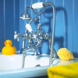 bathroom with blue wall shower duck and tap
