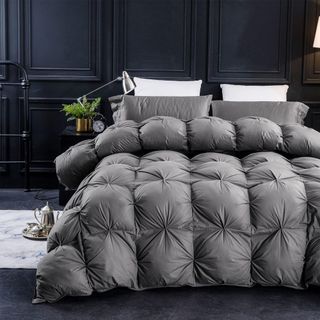 Pinch Pleat Comforter on a bed.