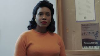 Weruche Opia as Coretta Scott King in an orange sweater in Genius: MLK/X